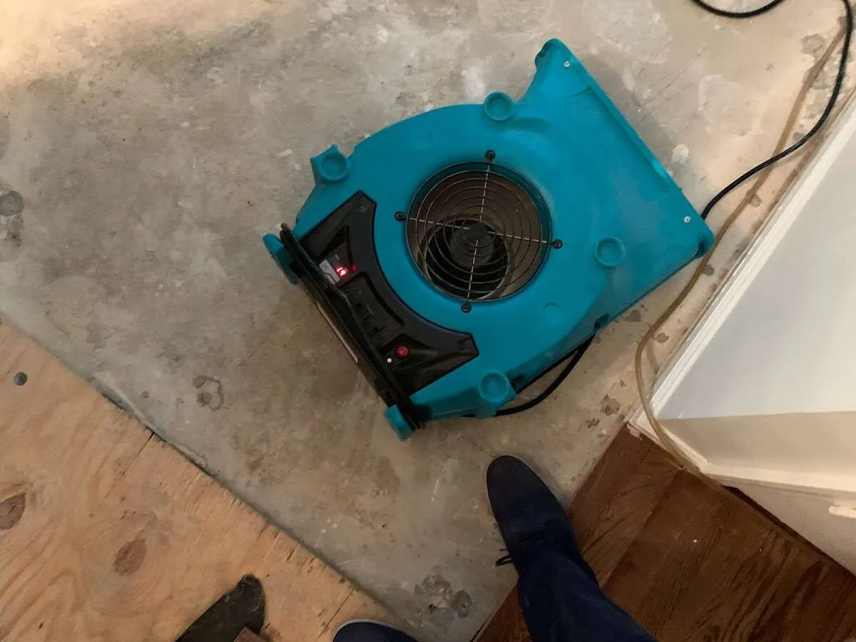 Air mover drying subfloor during Commercial Water Damage Restoration in Greenwood Village